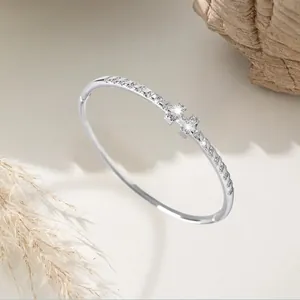 Detailed macro shot of a silver petal zircon bangle featuring elegant sparkling stone accents.