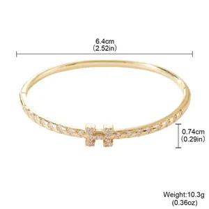 Elegant gold-toned bangle bracelet with pavé-set stones and H-motif motif dimensions