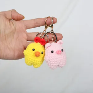 Handmade crochet animal keychains featuring a cute yellow chick and a pink pig charm