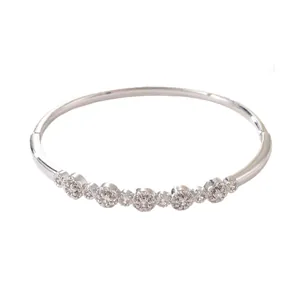 Elegant silver-toned bangle bracelet with sparkling flower-shaped zircon clusters