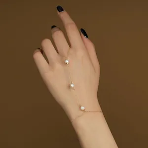 Gold-plated 925 sterling silver finger chain bracelet featuring elegant white pearls
