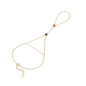 Detail view of s925 gold-plated finger bracelet with red and blue zircon stones
