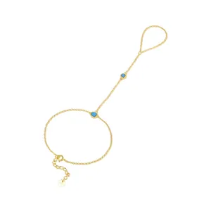 Detail of S925 sterling silver gold finger bracelet with elegant turquoise stones