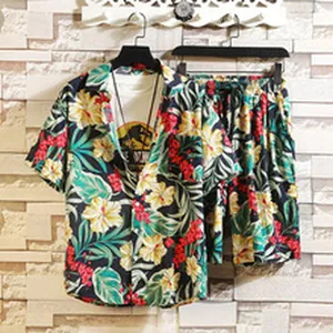 Detail of men's tropical floral Hawaiian shirt and shorts summer beach set