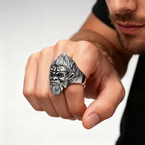 Detailed macro view of a vintage stainless steel Monkey King ring on a male finger.