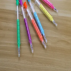 Creative colorful syringe-shaped gel pens for student stationery on a wooden desk
