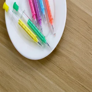 Close-up detail of creative syringe-shaped gel pens featuring colorful ink and scale marks