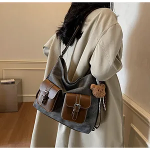Large grey denim texture tote bag with brown leather pockets and a bear charm for women