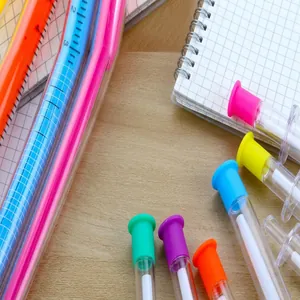 Detailed macro view of creative syringe-shaped gel pens on a grid notebook page