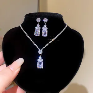 Close-up of sparkling crystal jewelry set with rectangular pendant and earrings