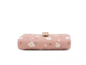 Detailed side view of pink floral print short wallet with gold metal buckle closure