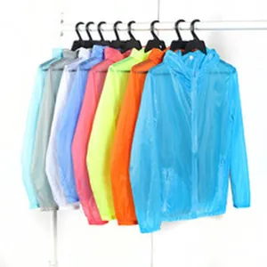 Lightweight hooded sun protection jackets in multiple colors displayed on a rack.