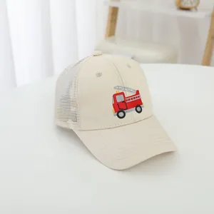 High-quality detail shot of a kids mesh baseball cap with red fire truck embroidery