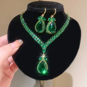 Elegant emerald green teardrop necklace and earrings jewelry set with vintage gold finish