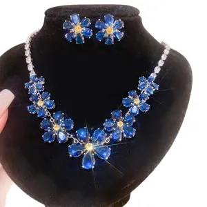 Luxury floral jewelry set featuring sparkling blue crystal necklace and stud earrings