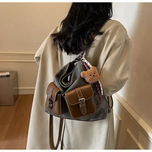 Vintage denim texture backpack for women shown worn with an elegant beige trench coat