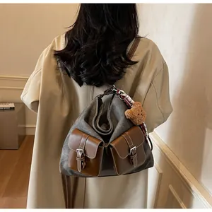 Vintage denim texture handbag for women featuring brown pockets and a cute teddy bear charm