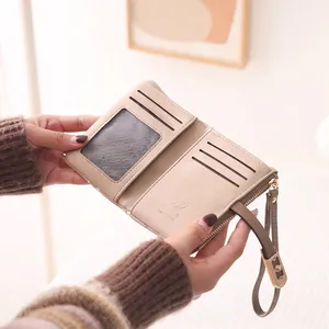 Elegant beige short bifold wallet for women featuring zipper and multiple card slots