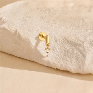 Detailed macro view of 16G gold plated s925 silver cartilage stud with CZ dangles