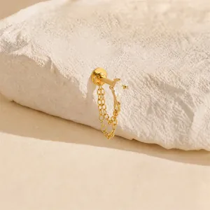 Detailed macro view of a gold-plated marquise stud earring with double layer chains