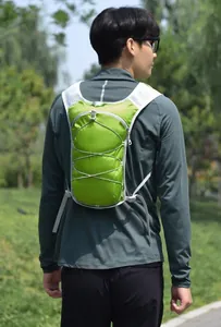 Back view of a male model wearing a lime green running hydration vest outdoors.