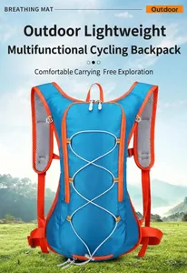 Front view of a blue and orange waterproof cycling backpack in a scenic mountain landscape.