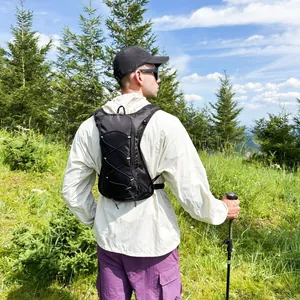 Active man wearing a waterproof black outdoor cycling backpack during a mountain hike trip