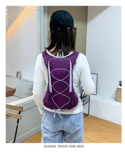 Purple water-resistant outdoor cycling backpack shown on a model's back view.