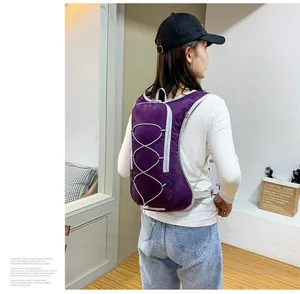 Lightweight purple water-resistant outdoor backpack for cycling and hiking on a model