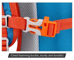 Detailed close-up of the durable orange chest strap buckle on a blue hiking backpack