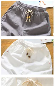 Close-up of breathable linen shorts with drawstring and wooden bead details