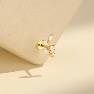 Macro view of a gold-tone branch cartilage earring with sparkling clear cubic zirconia