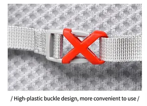 Detail of durable red X-shaped buckle on a gray running vest backpack