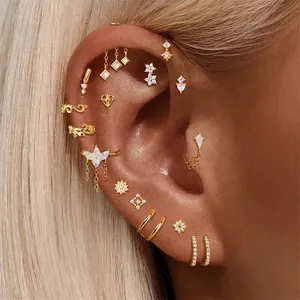 S925 sterling silver cartilage earrings and gold cuffs set displayed on a model's ear