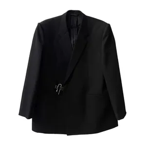 Detail of a unique U-shaped silver metal buckle on a men's black blazer jacket