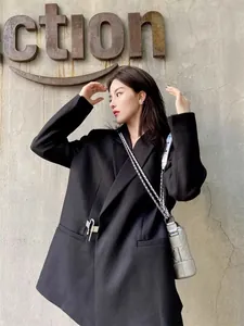 Chic oversized black casual blazer with unique silver metal pin detail in street style
