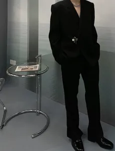 Fashionable men's casual black suit set featuring unique silver pin detail detail