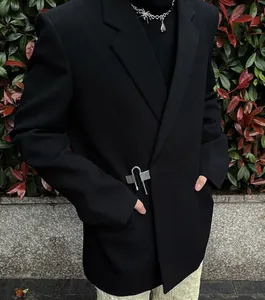 Detail shot of a black men's casual blazer with creative metal lock buckle closure
