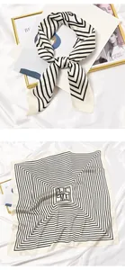 Detailed view of a retro silk square scarf with black and white geometric patterns