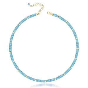 Macro view of a light blue natural stone beaded necklace with gold-toned spacers