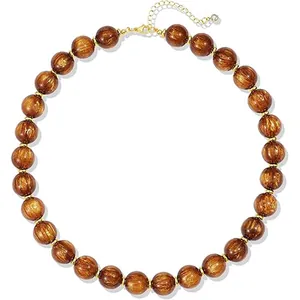 Bohemian style chunky necklace with golden brown resin beads and adjustable chain
