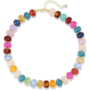 Detailed view of bohemian multi-color resin barrel beaded necklace with gold clasp