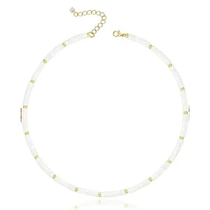 Detailed view of white natural stone heishi bead necklace with gold spacers clasp