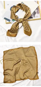 Detailed view of vintage mustard yellow square scarf with white geometric stripe patterns