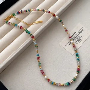 Detailed view of rainbow natural stone necklace with freshwater pearls and gold beads.