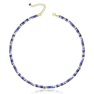 Detailed close-up of a blue natural stone bead necklace with golden spacer beads