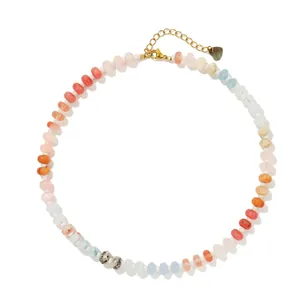 Circular layout of rainbow chalcedony flat bead necklace with gold heart clasp.