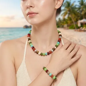 Detail view of colorful resin bead necklace and bracelet set on a beach vacation.