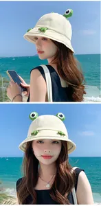 Detailed view of a cute cream-colored frog bucket hat for summer sun protection outdoors
