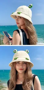 Detailed view of a cute cream-colored frog bucket hat for summer sun protection outdoors